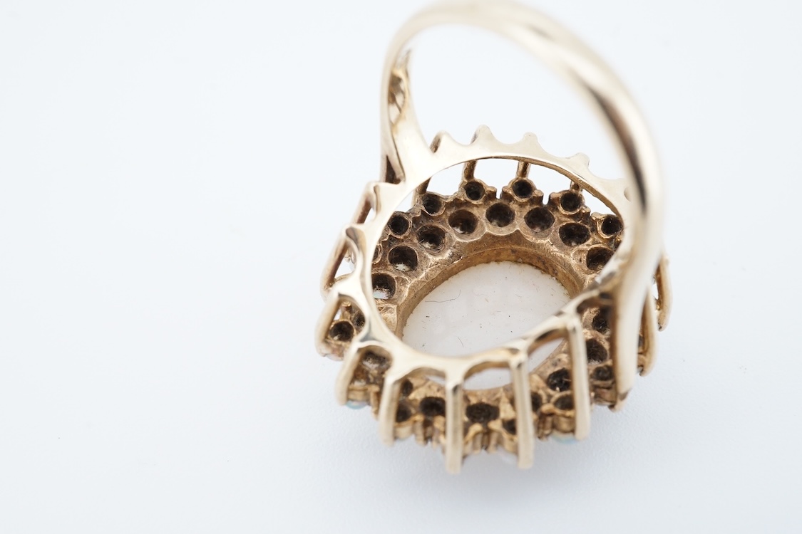 An early 1970's 9ct gold and opal cluster set dress ring, size O, gross weight 9 grams.